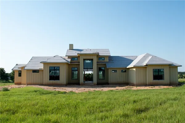 a view of a house with a backyard and porch