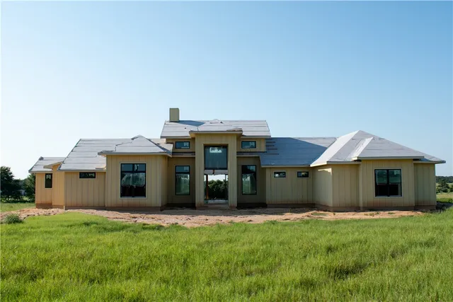a view of a house with a backyard and porch