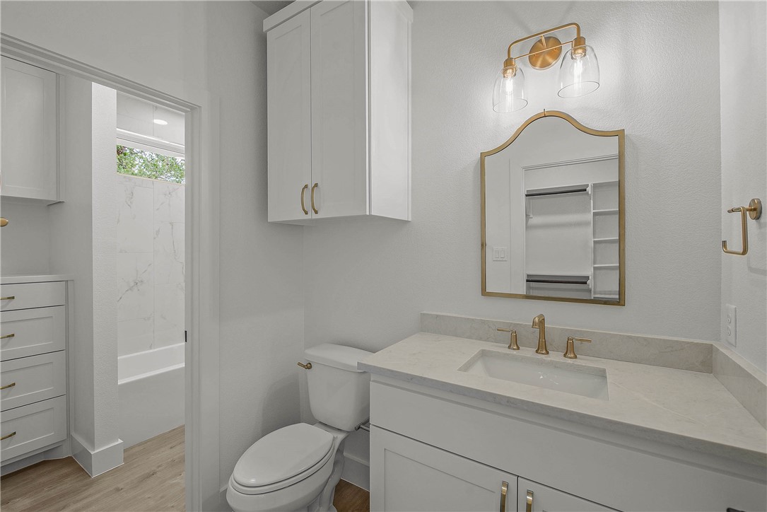 2201 High Meadows Trail Franklin, TX 77856 - Photo 31 of 50 a bathroom with a granite countertop sink vanity mirror and toilet