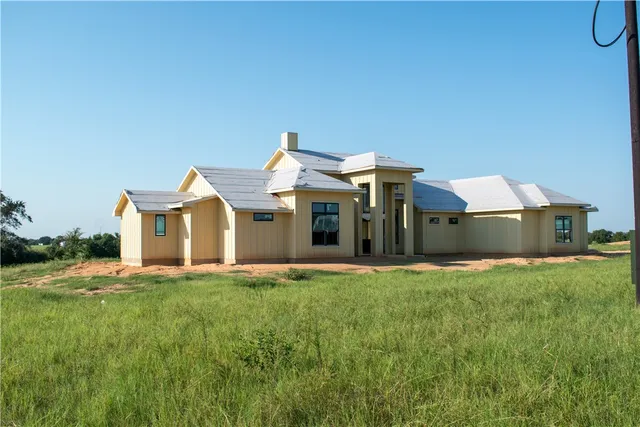 a view of a house with backyard porch and sitting area