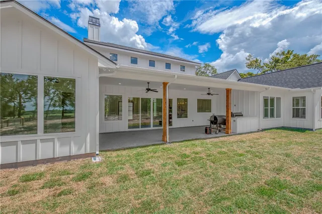 an empty room with floor to ceiling window and fireplace