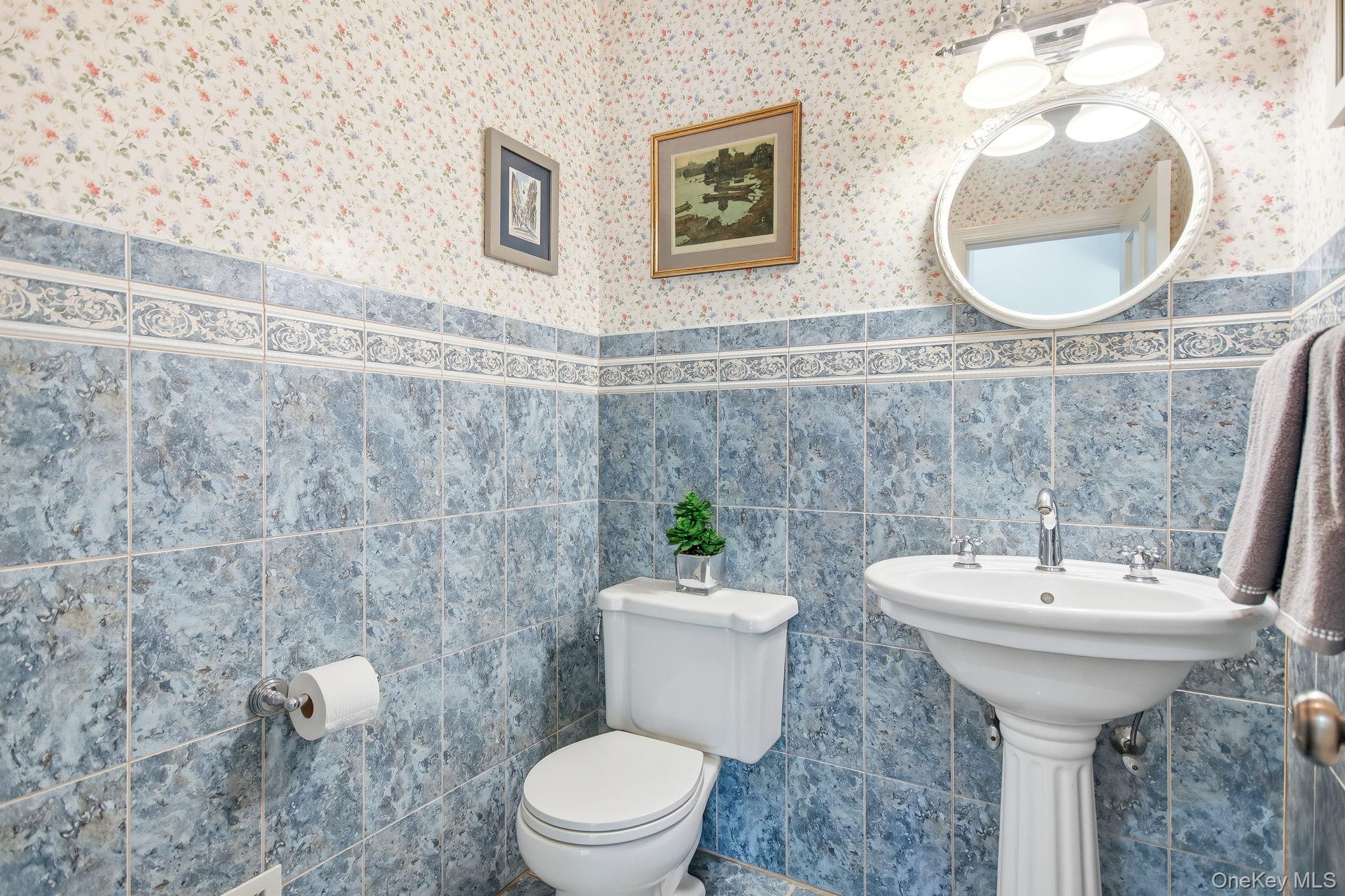 26 Century Ridge Road Purchase, NY 10577 - Photo 14 of 50 Powder room featuring a pedestal sink with chrome faucet, complemented by blue patterned wall tiling and a decorative border