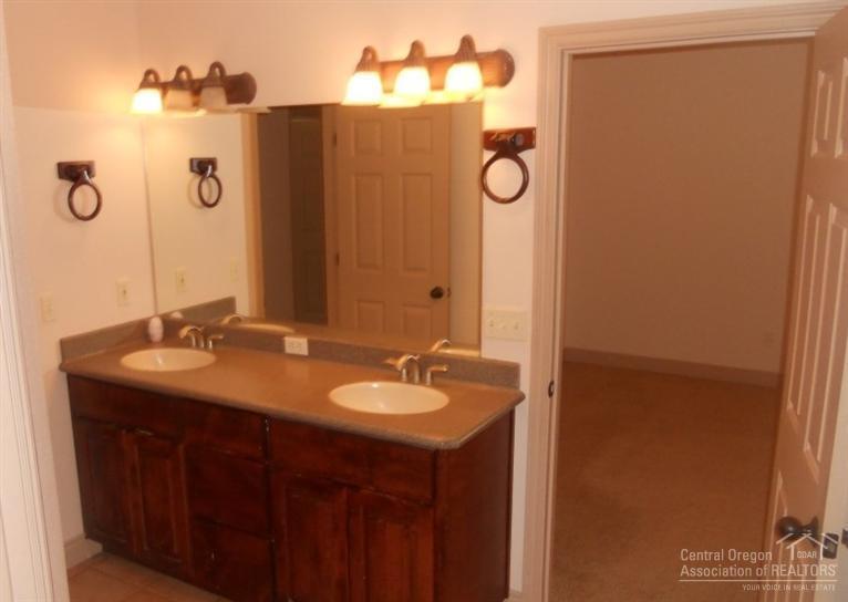 60120 East Ridgeview Drive Bend, OR 97702 - Photo 11 of 14 a bathroom with a granite countertop sink and a mirror
