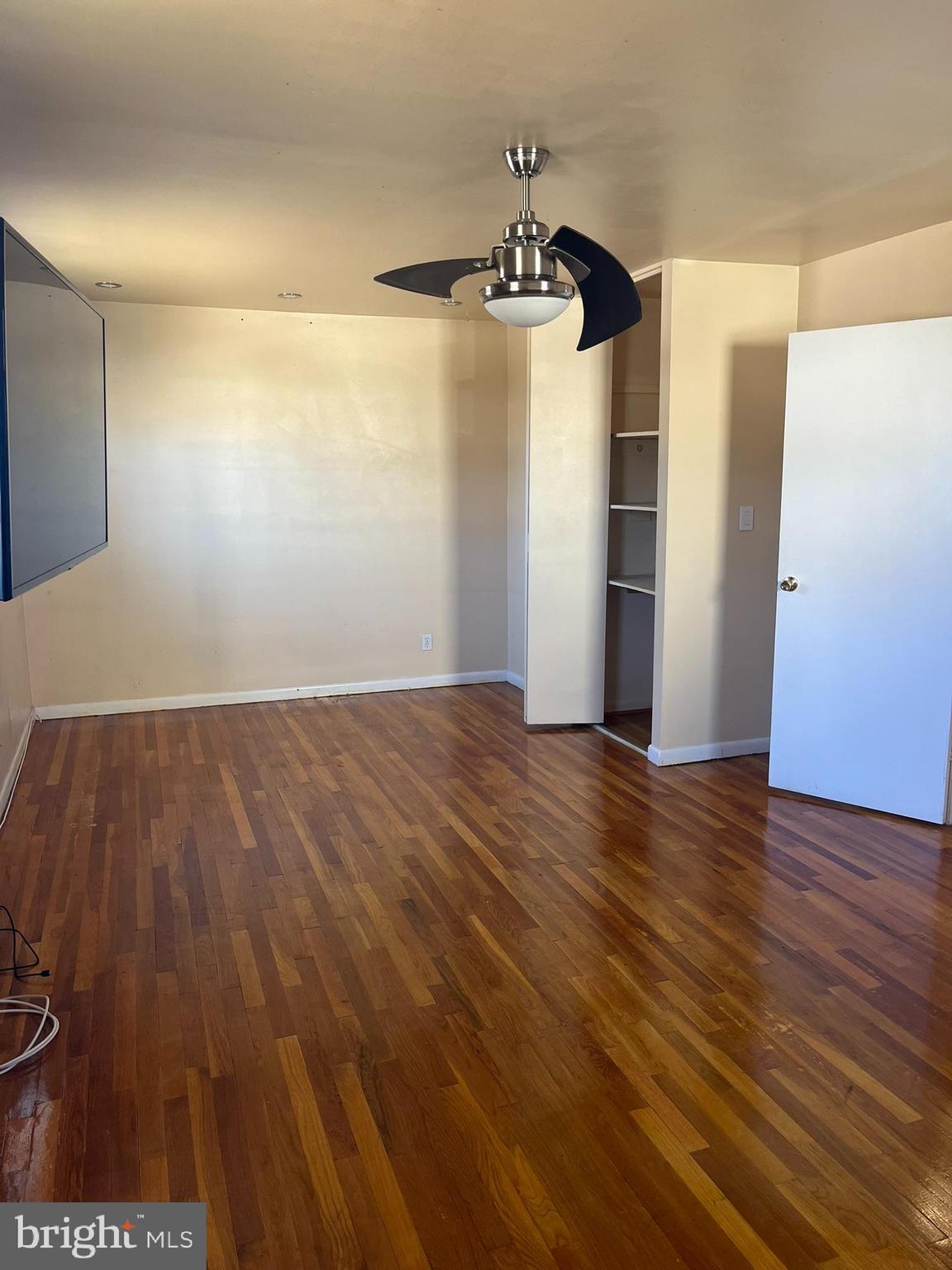 3806 Byxbee Road Randallstown, MD 21133 - Photo 11 of 18 wooden floor in an empty room with a window