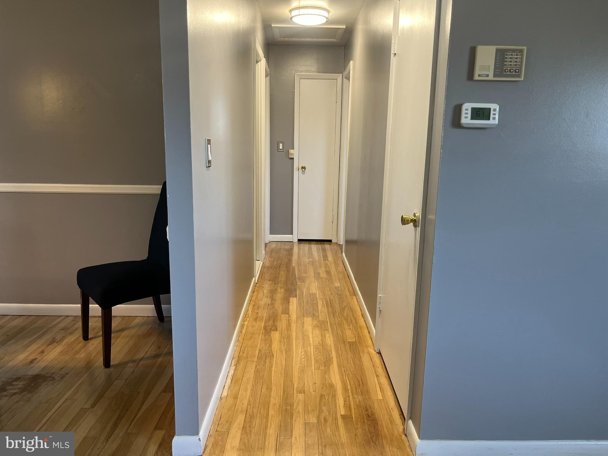 3806 Byxbee Road Randallstown, MD 21133 - Photo 8 of 18 a view of a hallway with wooden floor and a bathroom