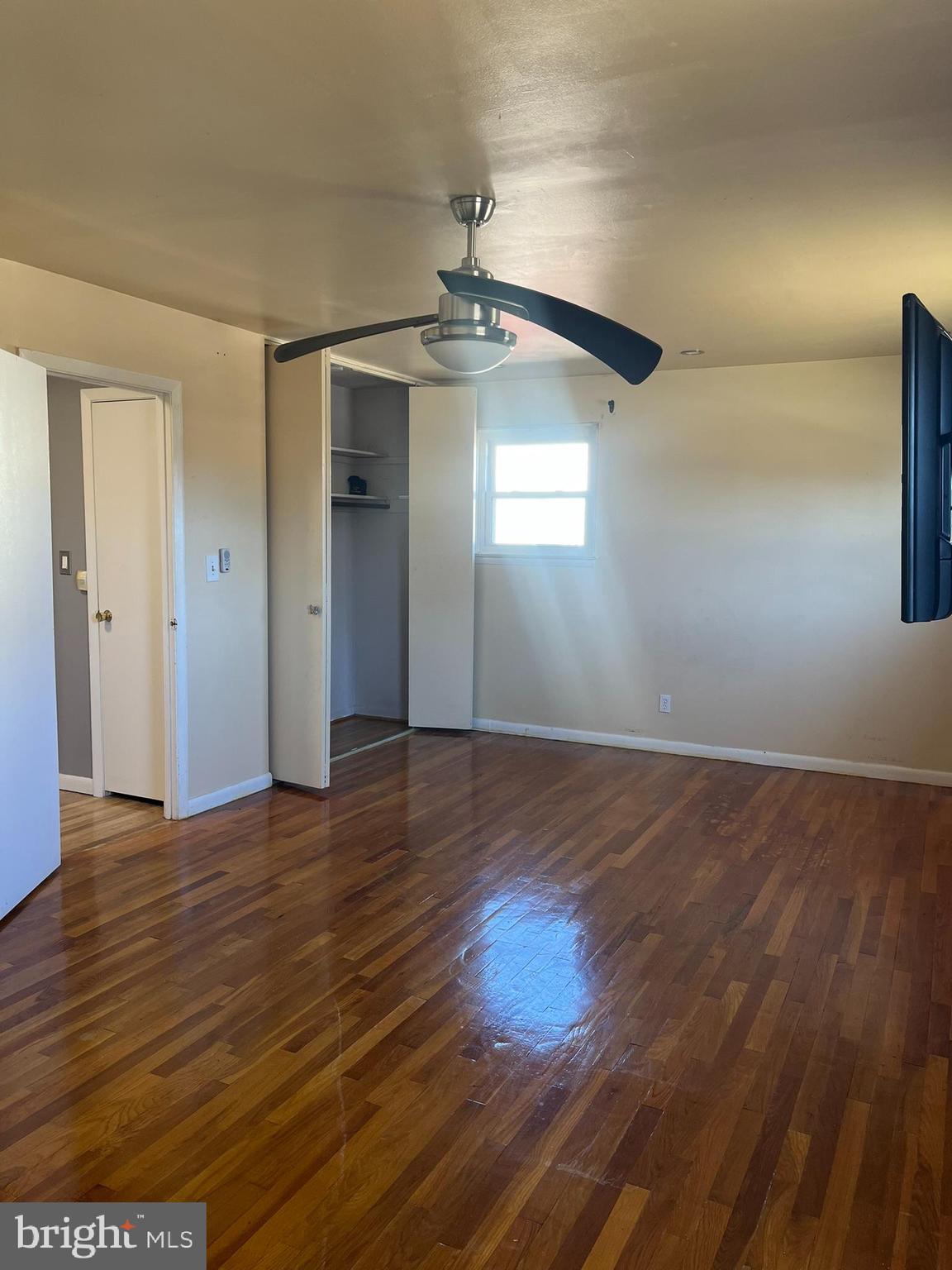 3806 Byxbee Road Randallstown, MD 21133 - Photo 10 of 18 wooden floor in an empty room with a window