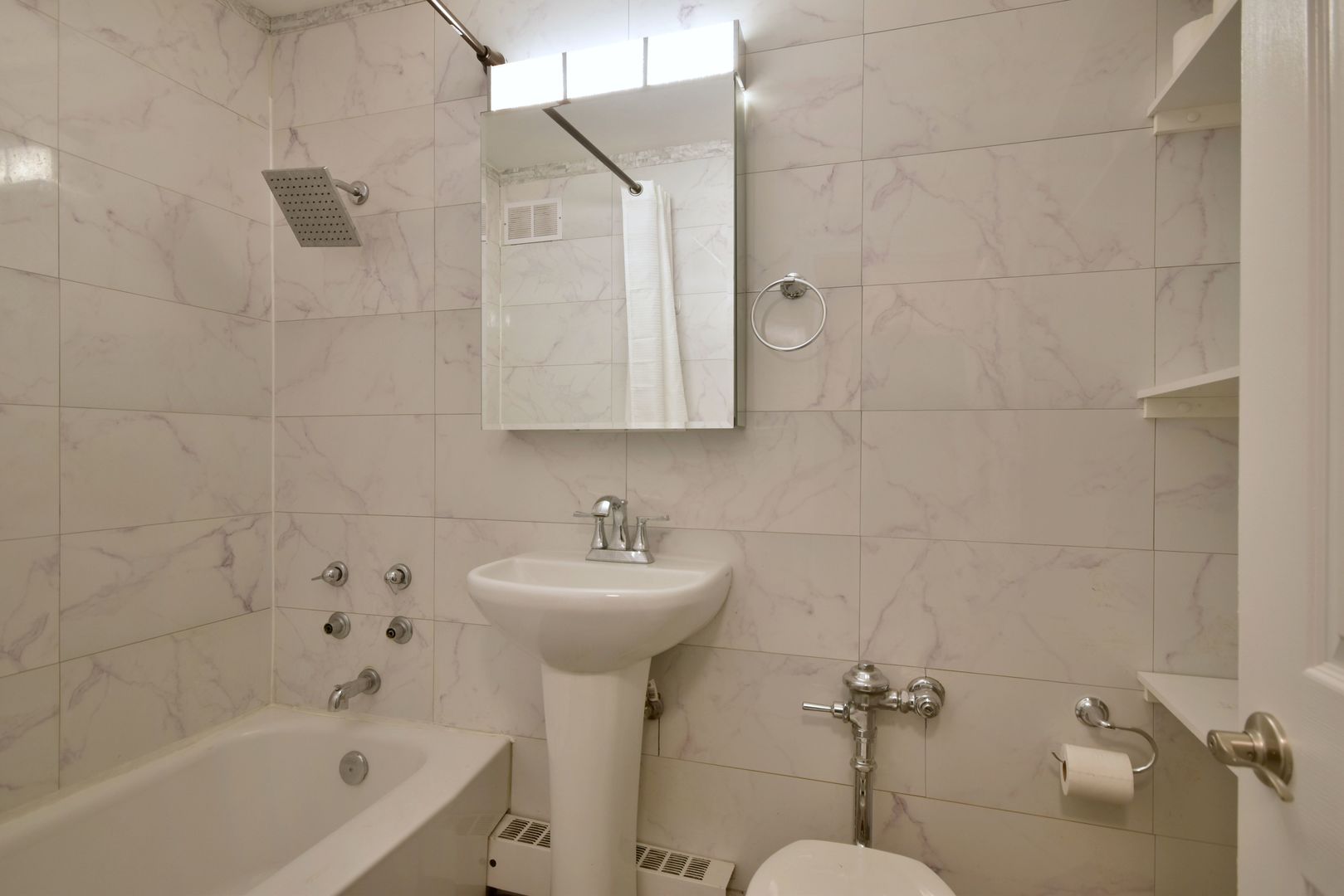 6118 North Sheridan Road, Unit 406 Chicago, IL 60660 - Photo 22 of 26 a bathroom with a sink a toilet and shower