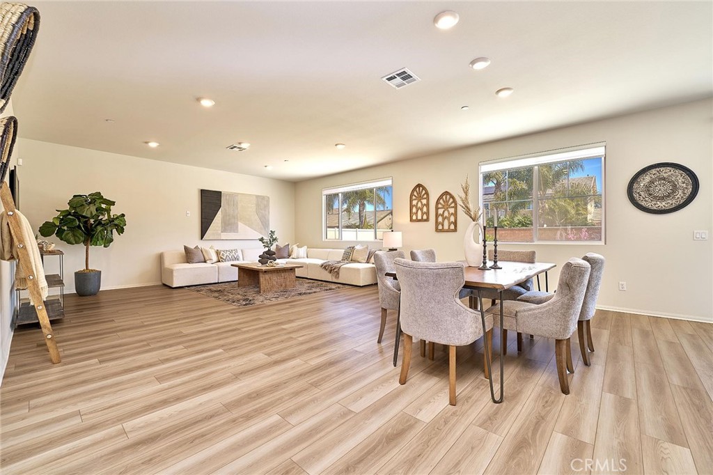 32846 Forgecroft Street Menifee, CA 92584 - Photo 11 of 48 a view of a dining room with furniture and wooden floor