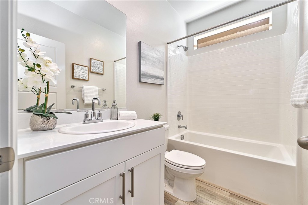 32846 Forgecroft Street Menifee, CA 92584 - Photo 17 of 48 a bathroom with a sink a toilet and a mirror