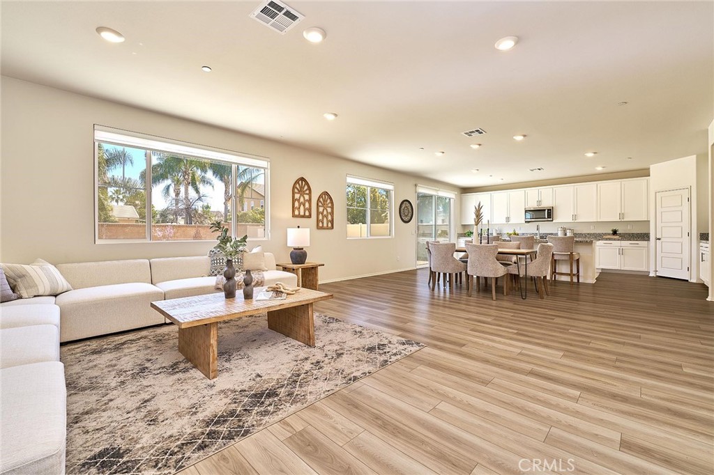 32846 Forgecroft Street Menifee, CA 92584 - Photo 2 of 48 a living room with furniture and a wooden floor