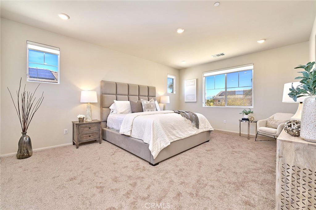 32846 Forgecroft Street Menifee, CA 92584 - Photo 24 of 48 a bedroom with a bed and a couch