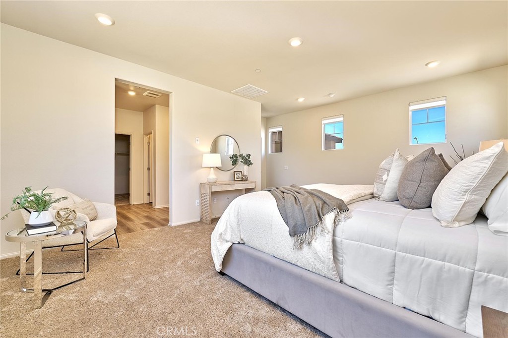 32846 Forgecroft Street Menifee, CA 92584 - Photo 25 of 48 a spacious bedroom with a bed and window