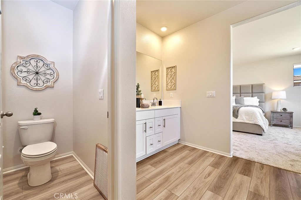 32846 Forgecroft Street Menifee, CA 92584 - Photo 28 of 48 a bathroom with a toilet sink and mirror