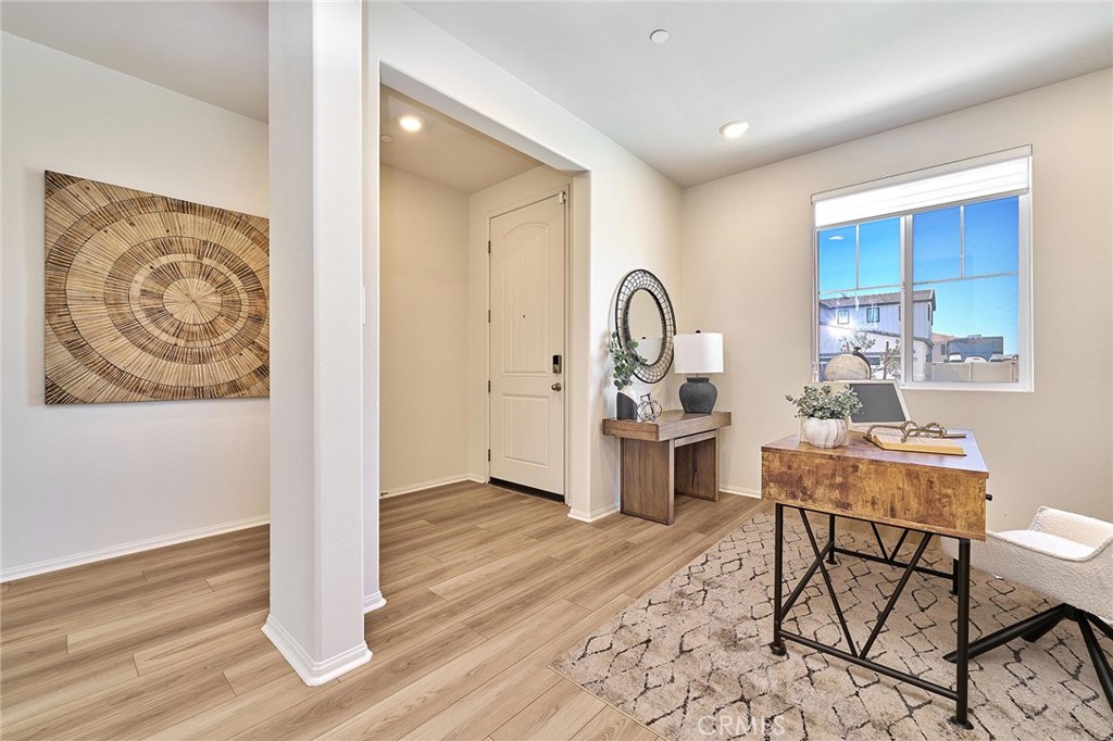 32846 Forgecroft Street Menifee, CA 92584 - Photo 3 of 48 a living room with furniture a rug and a painting on the wall