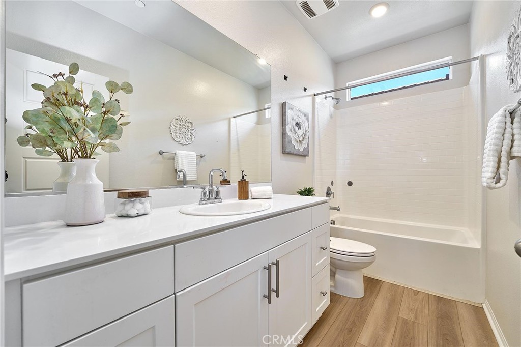 32846 Forgecroft Street Menifee, CA 92584 - Photo 31 of 48 a bathroom with a granite countertop sink a toilet and shower