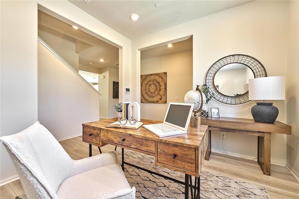 32846 Forgecroft Street Menifee, CA 92584 - Photo 4 of 48 a living room with furniture a mirror and a table