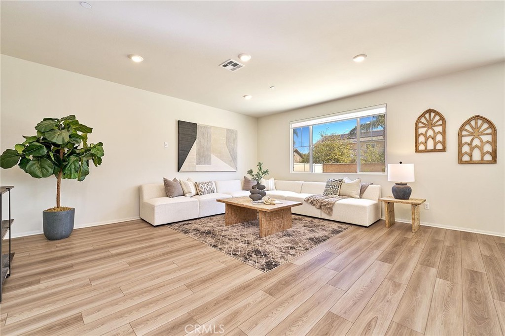 32846 Forgecroft Street Menifee, CA 92584 - Photo 9 of 48 a living room with furniture and a table