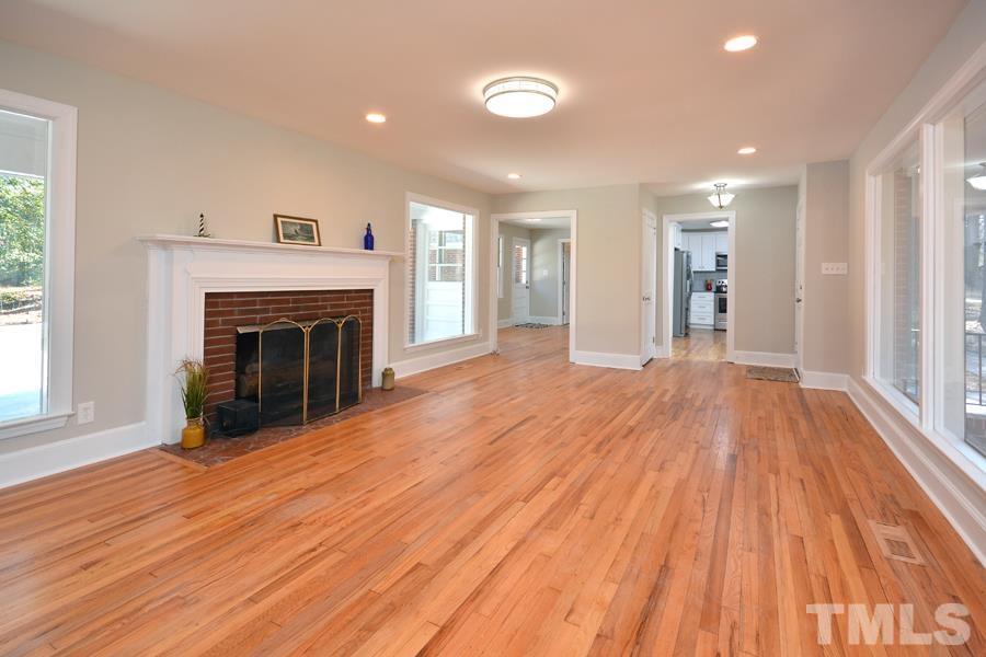 402 Monticello Avenue Durham, NC 27707 - Photo 13 of 24 a view of empty room with wooden floor and fireplace