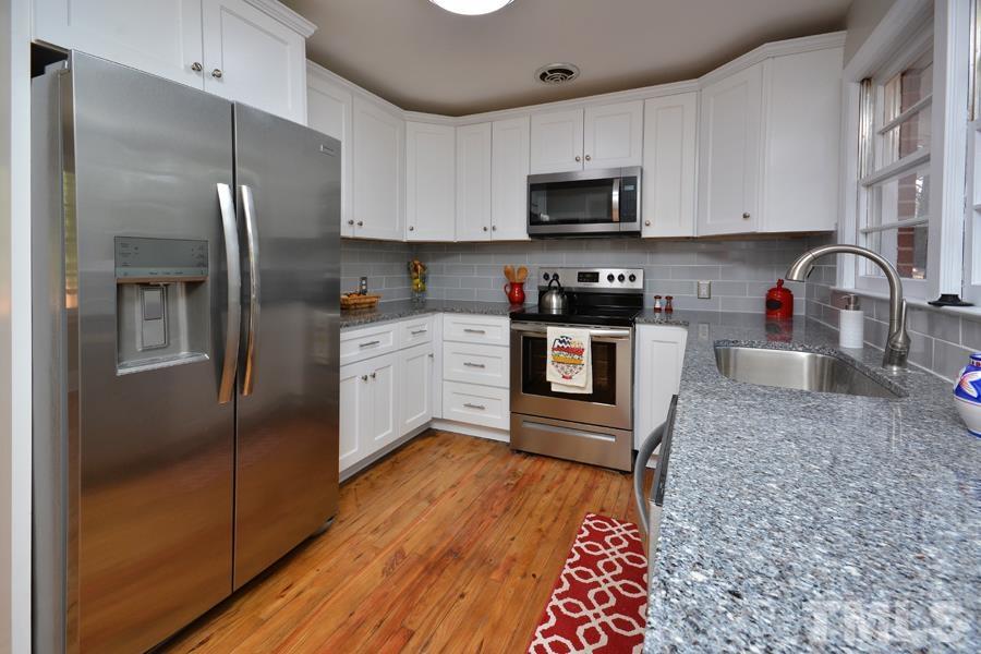 402 Monticello Avenue Durham, NC 27707 - Photo 14 of 24 a kitchen with stainless steel appliances granite countertop a refrigerator sink and stove