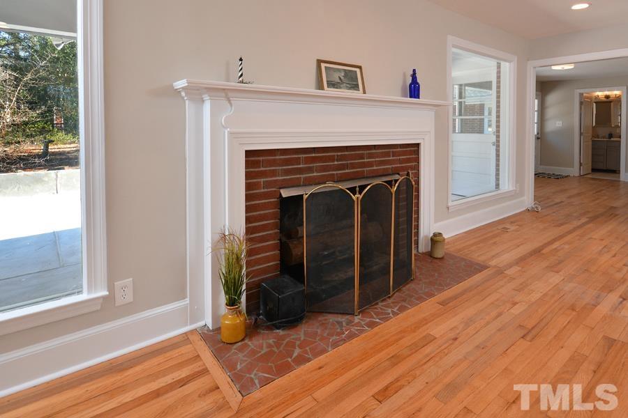 402 Monticello Avenue Durham, NC 27707 - Photo 16 of 24 a living room with furniture and a fireplace