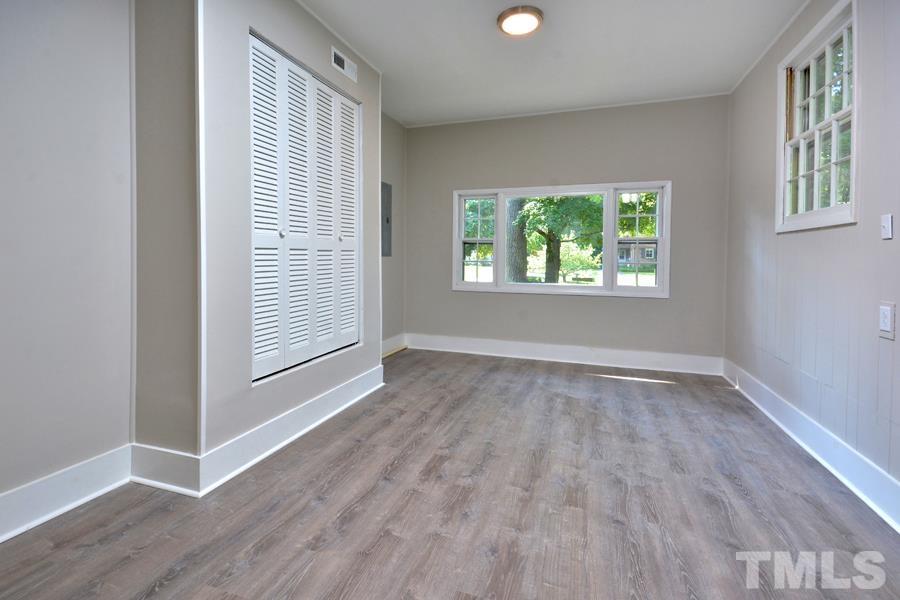 402 Monticello Avenue Durham, NC 27707 - Photo 17 of 24 an empty room with wooden floor and windows