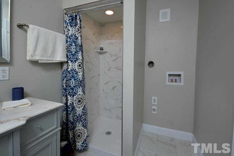 402 Monticello Avenue Durham, NC 27707 - Photo 18 of 24 a bathroom with a shower curtain and a sink