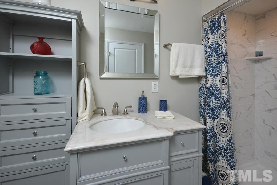 402 Monticello Avenue Durham, NC 27707 - Photo 19 of 24 a bathroom with a sink and a mirror