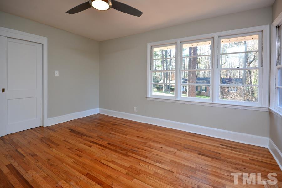 402 Monticello Avenue Durham, NC 27707 - Photo 20 of 24 a view of empty room with wooden floor and fan