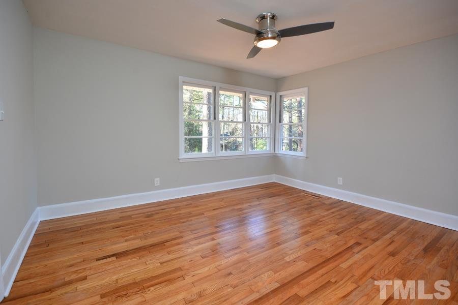 402 Monticello Avenue Durham, NC 27707 - Photo 21 of 24 a view of empty room with wooden floor and fan