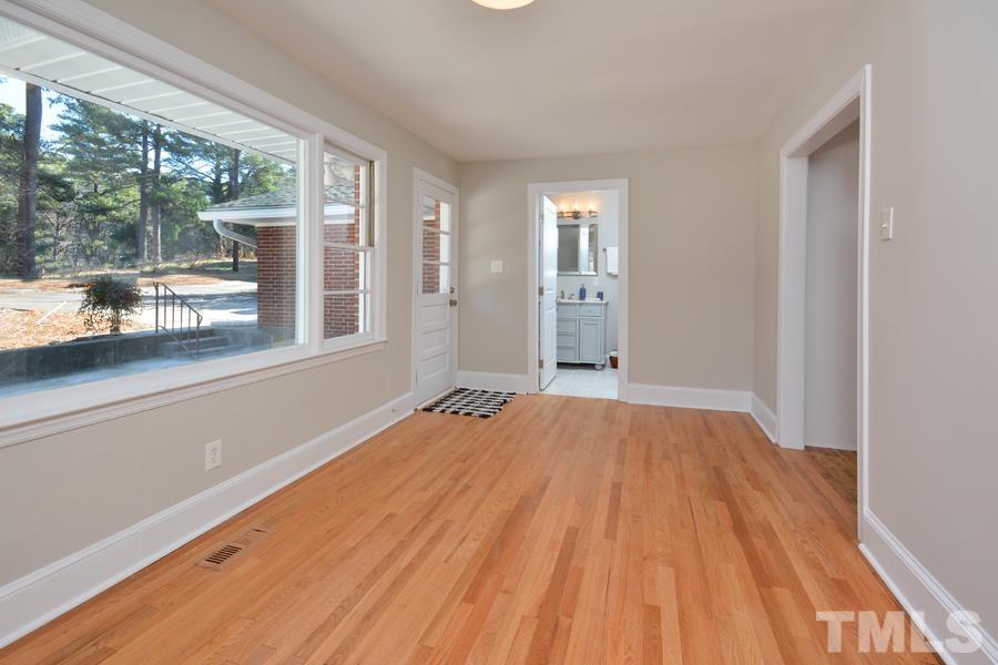 402 Monticello Avenue Durham, NC 27707 - Photo 8 of 24 a view of an empty room with wooden floor and a window