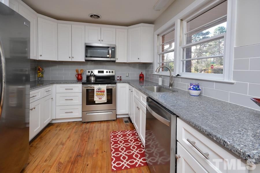 402 Monticello Avenue Durham, NC 27707 - Photo 9 of 24 a kitchen with stainless steel appliances granite countertop a sink dishwasher a stove and a microwave oven with cabinets