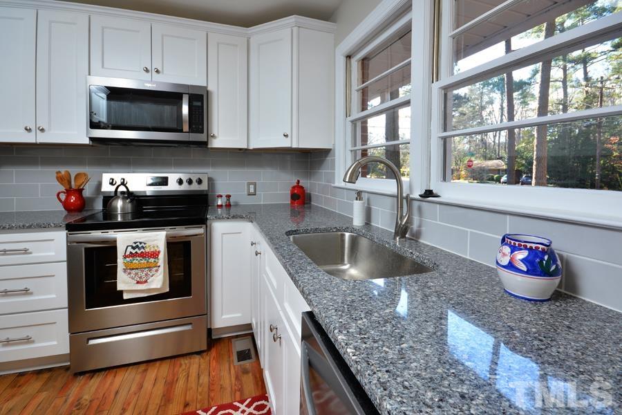 402 Monticello Avenue Durham, NC 27707 - Photo 10 of 24 a kitchen with stainless steel appliances granite countertop a sink and a microwave