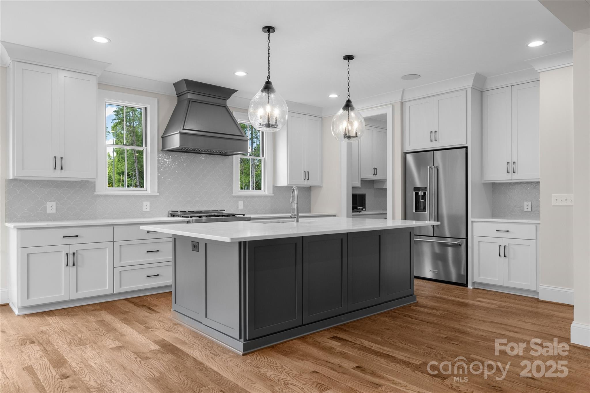 537 Riddle Mill Road Clover, SC 29710 - Photo 14 of 47 a large kitchen with white cabinets and stainless steel appliances