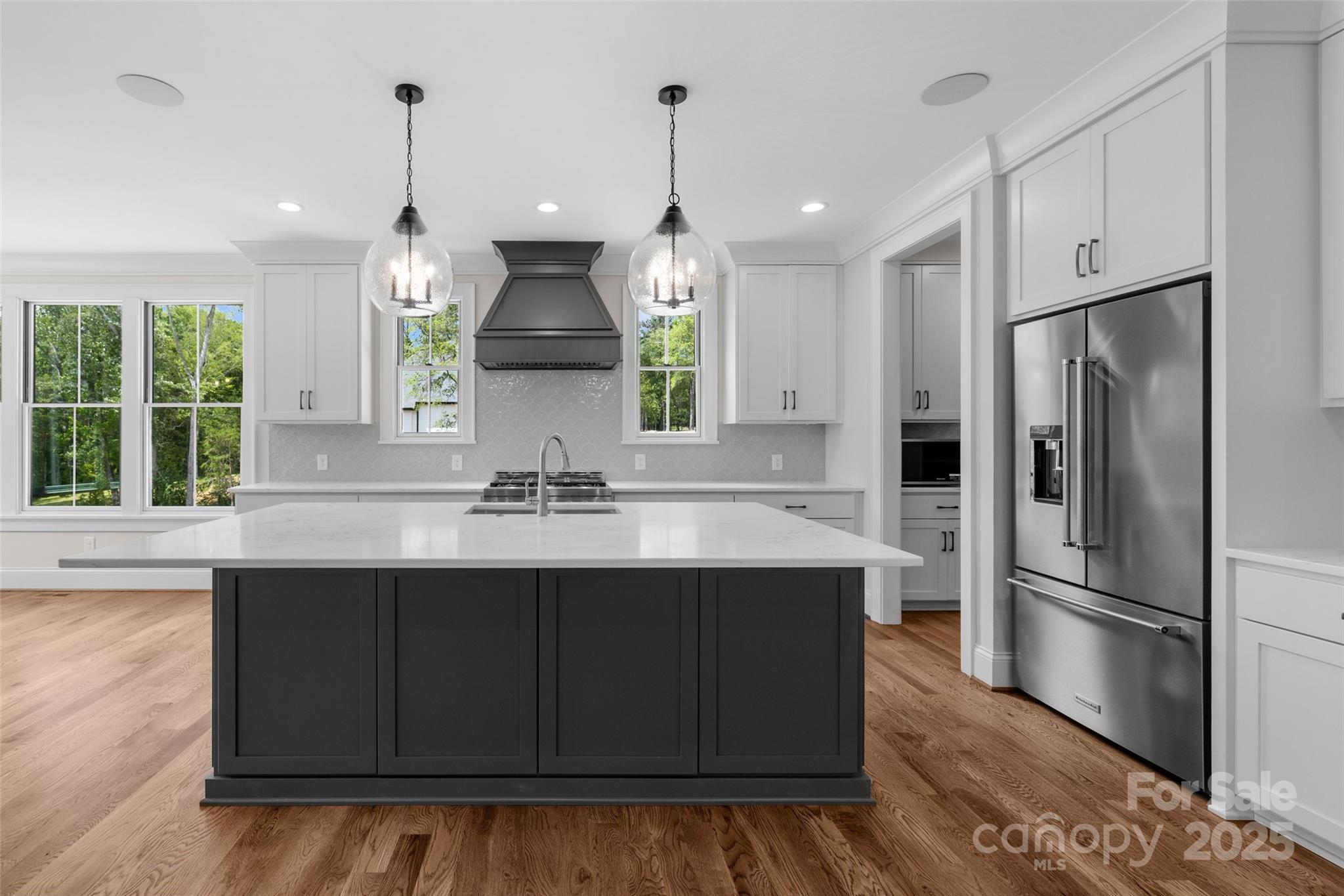 537 Riddle Mill Road Clover, SC 29710 - Photo 15 of 47 a kitchen with kitchen island granite countertop a sink a counter space appliances and cabinets