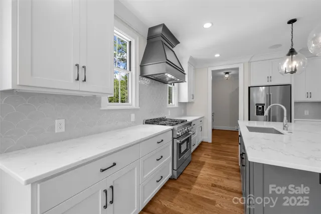 a kitchen with stainless steel appliances granite countertop a sink and stove