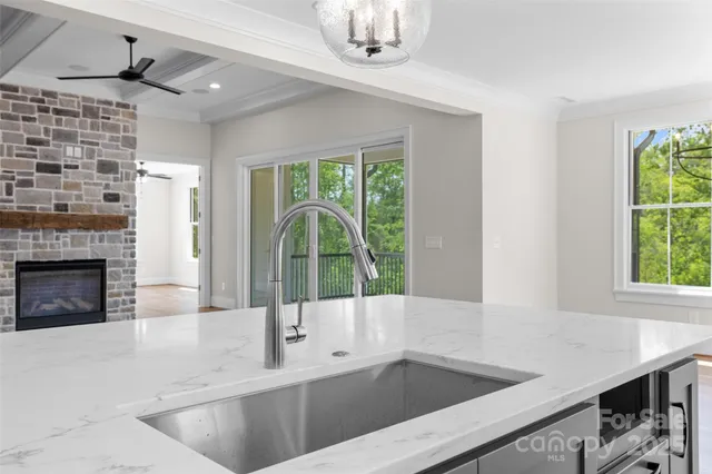 a kitchen with a sink and a large window