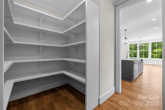 a storage room with wooden floor and windows