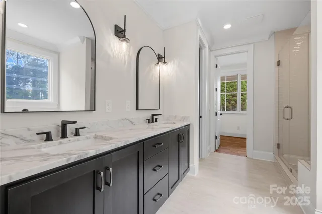 a bathroom with double sink and a mirror