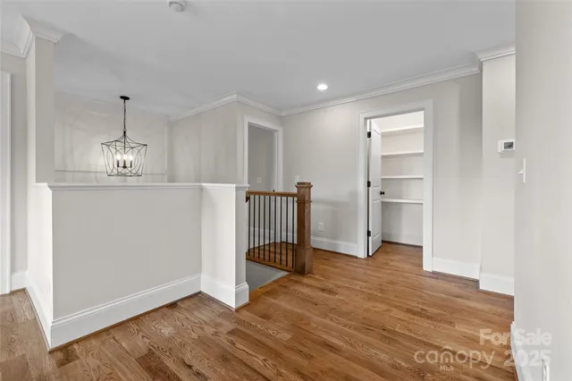 a view of a room with wooden floor entryway and windows