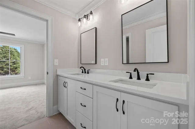 a bathroom with double sink and a mirror