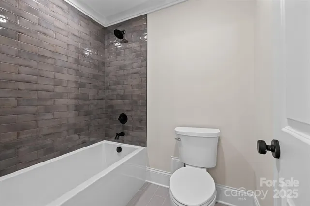 a bathroom with a toilet and shower