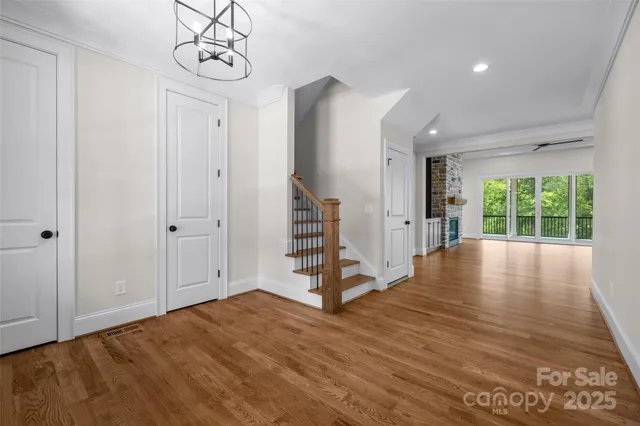 a view of empty room with wooden floor and window