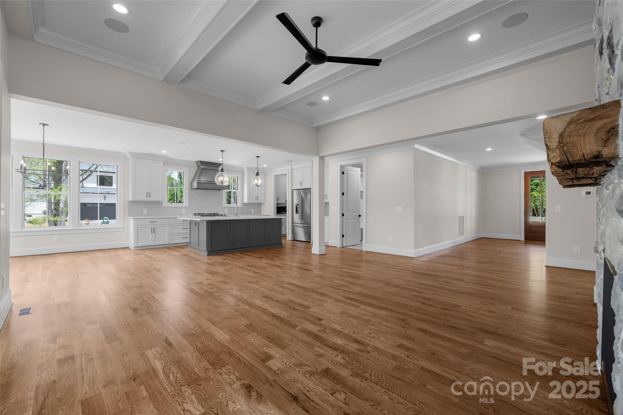 537 Riddle Mill Road Clover, SC 29710 - Photo 10 of 47 a view of empty room with wooden floor and a kitchen