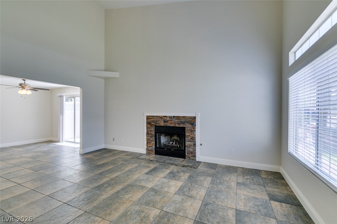 200 Luninborg Street Henderson, NV 89074 - Photo 11 of 40 Dramatic vaulted ceilings crown a sun-drenched living area with a cozy stone-accented fireplace.