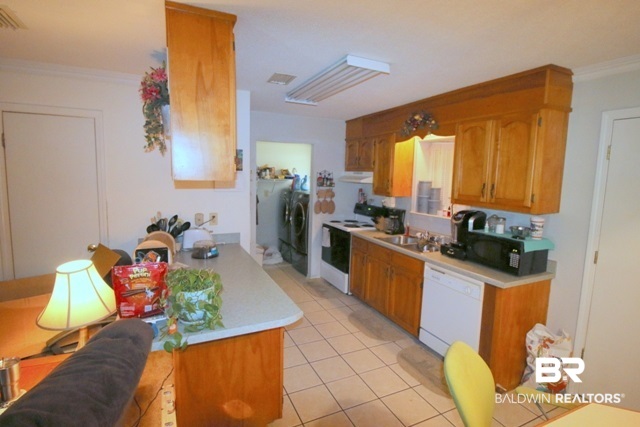16809 River Park Road Fairhope, AL 36532 - Photo 15 of 18 Main view of kitchen with laundry room and pantry.