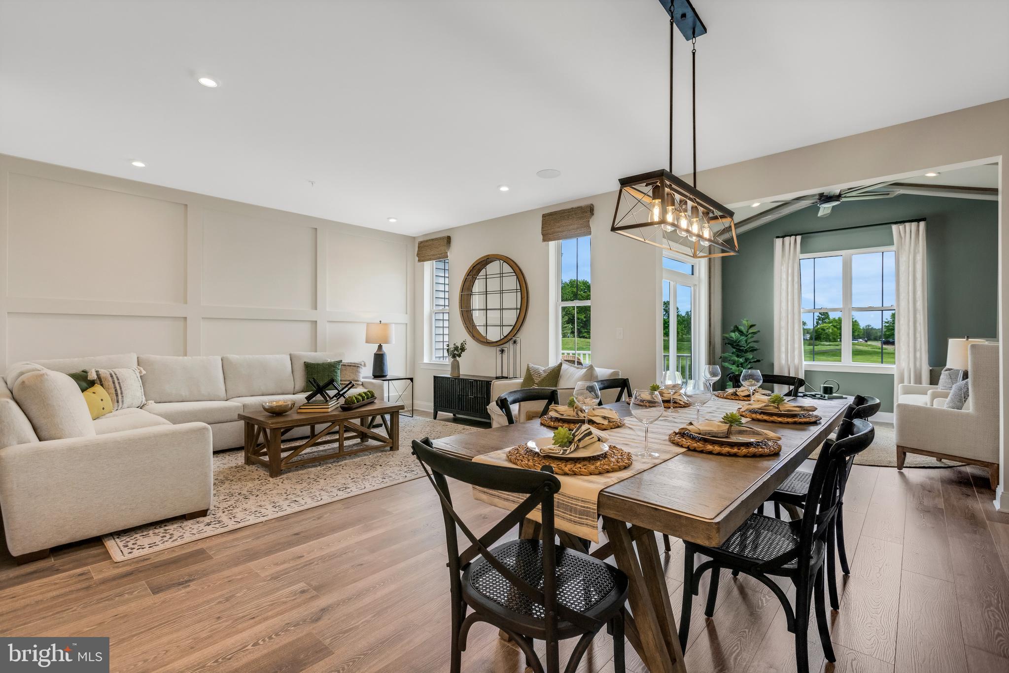 2 Baldwin Way Perkasie, PA 18944 - Photo 11 of 44 a view of a dining room and livingroom with furniture wooden floor a chandelier