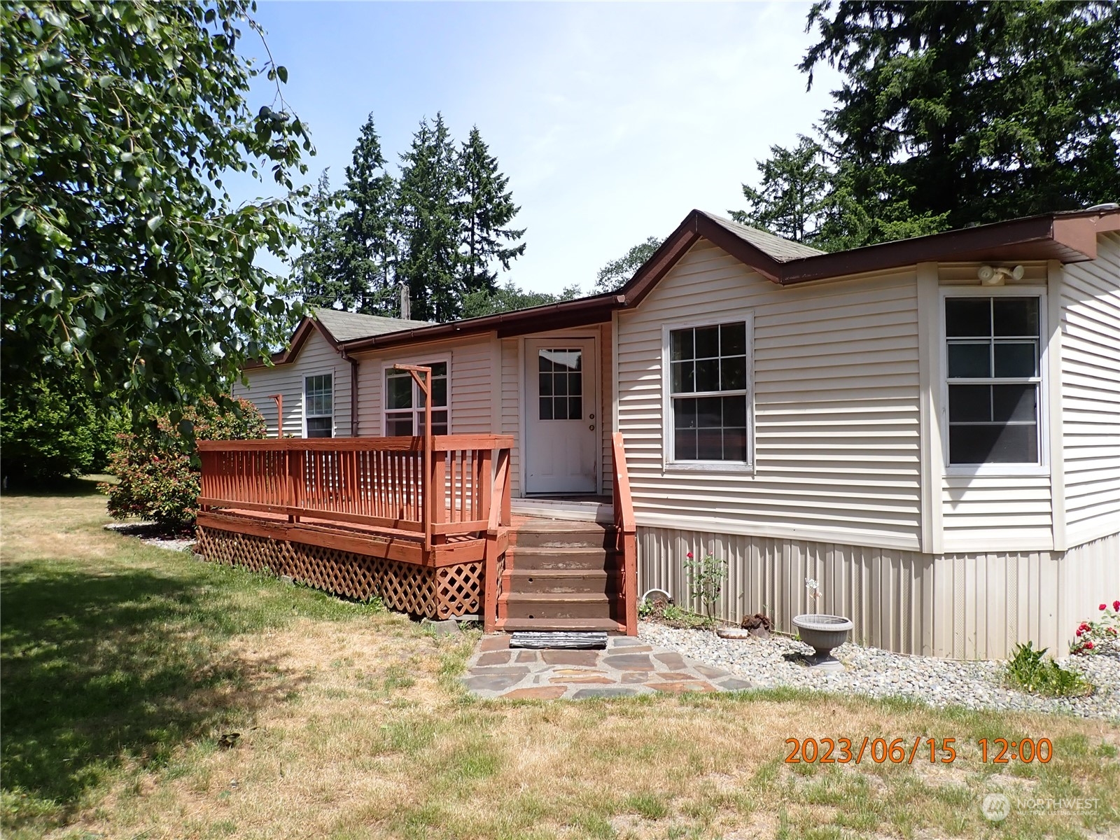 a view of a house with a yard and wooden fence