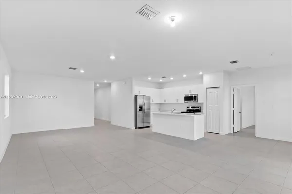 a kitchen with stainless steel appliances a refrigerator and a stove top oven