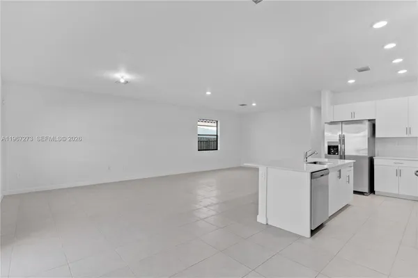 a kitchen with stainless steel appliances a stove a sink a microwave and cabinets