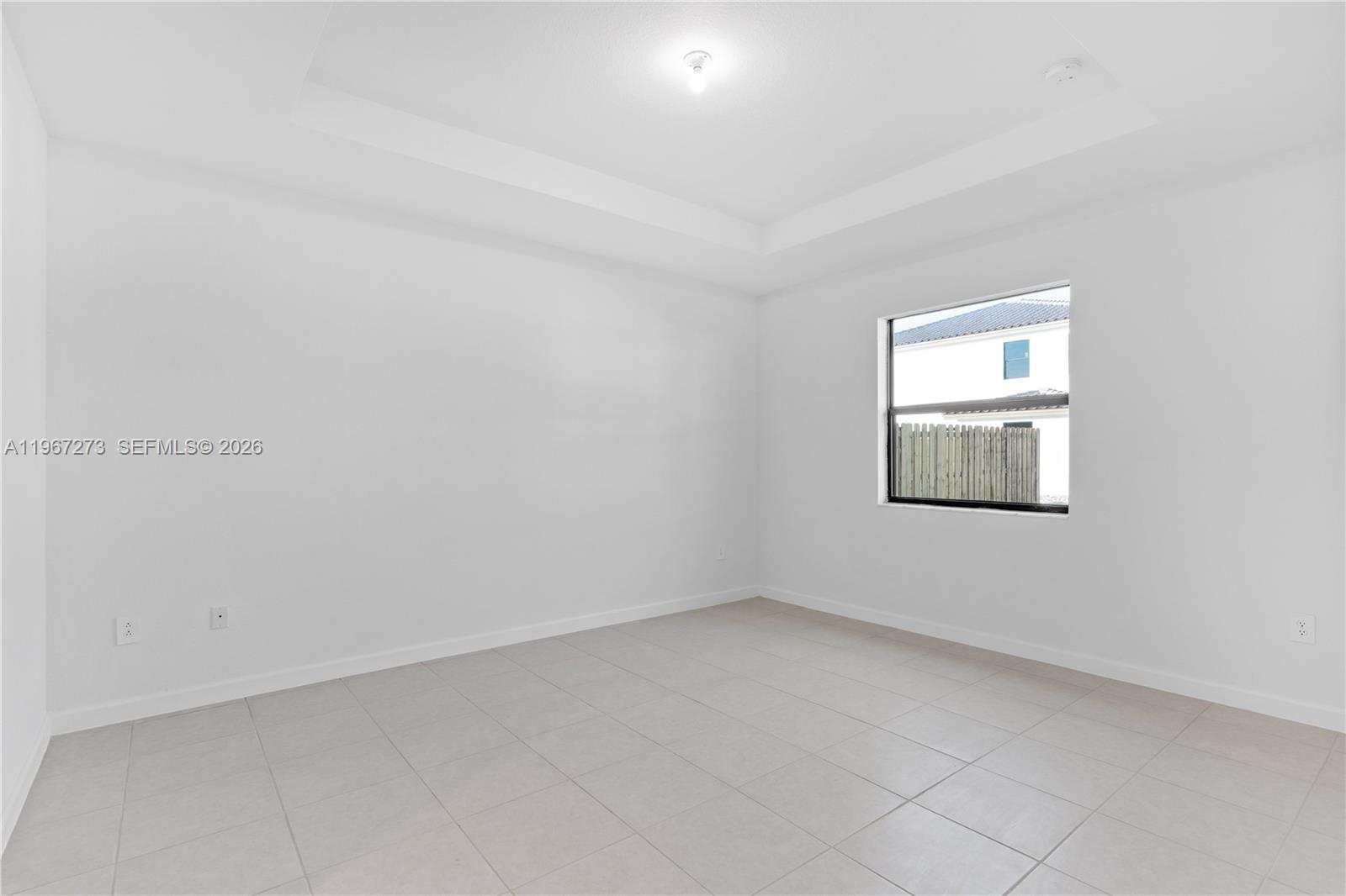 11947 Southwest 241 Terrace Homestead, FL 33032 - Photo 16 of 32 an empty room with a window